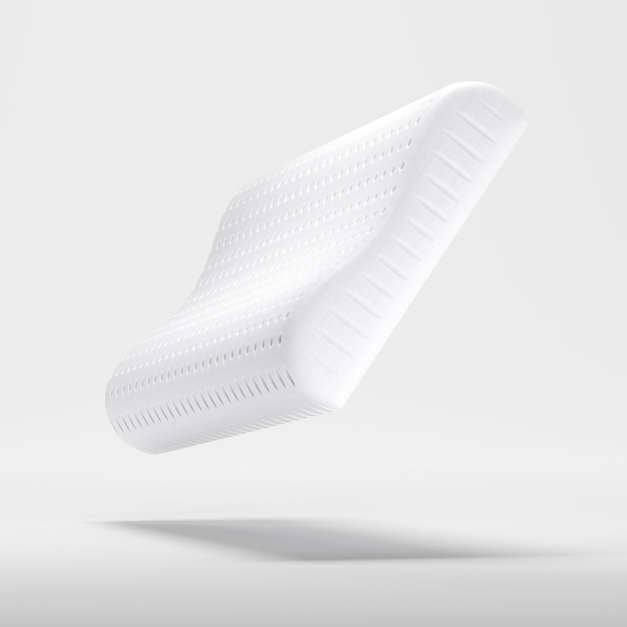 Profilansicht des perforierten Xleep NeXleep Kissenkerns ohne Bezug zur Verdeutlichung der ergonomischen Wellenform.